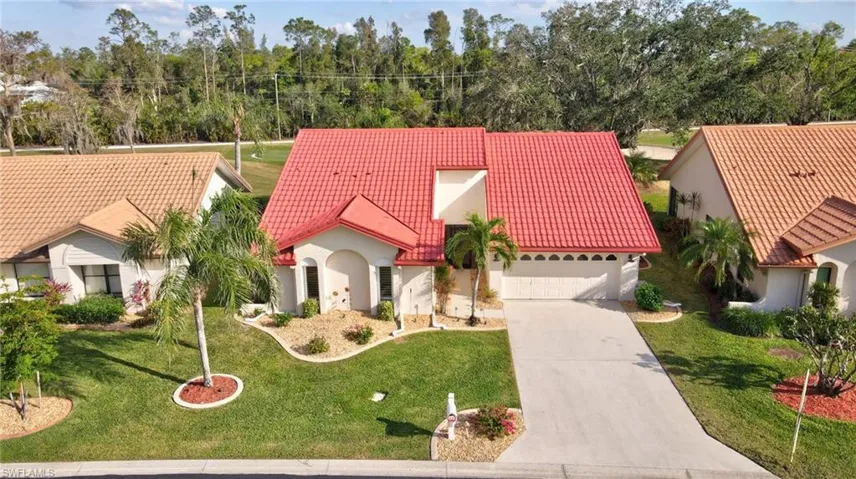View of front of house featuring a garage and a front lawn
