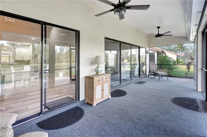 Sunroom with ceiling fan and vaulted ceiling