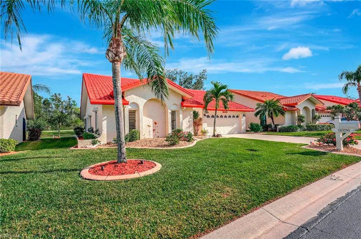 Mediterranean / spanish home with a garage and a front yard