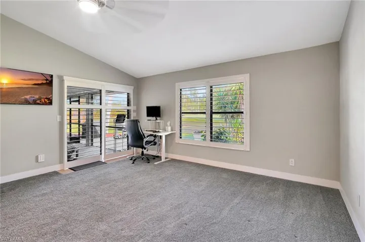 Unfurnished office with carpet floors and lofted ceiling