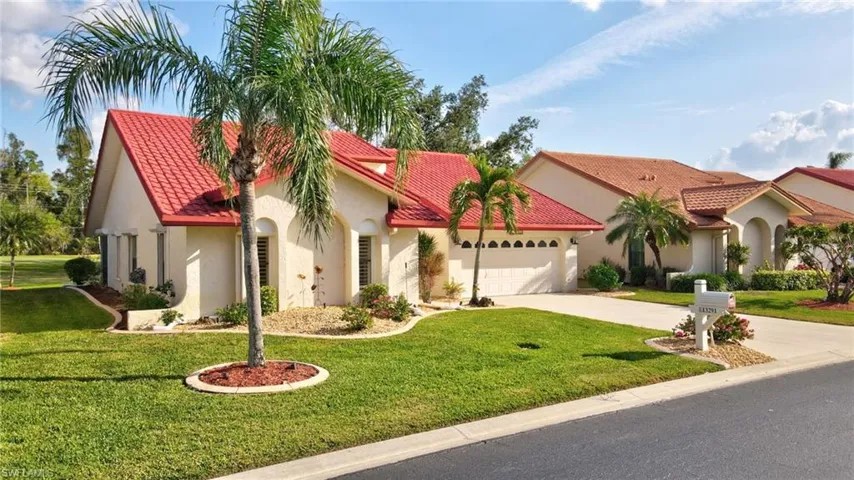 Mediterranean / spanish-style house featuring a garage and a front yard