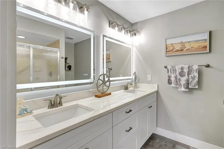 Bathroom with vanity and a shower with shower door
