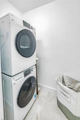 Laundry area featuring stacked washer / drying machine
