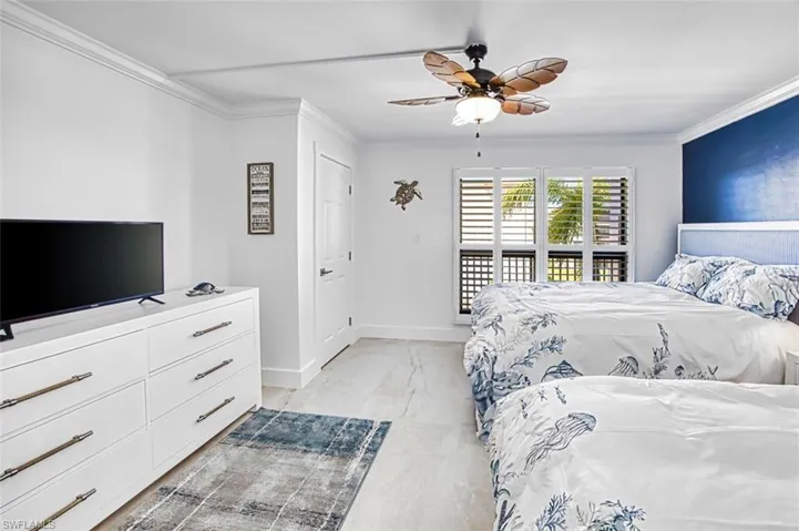 Bedroom featuring ornamental molding and a ceiling fan