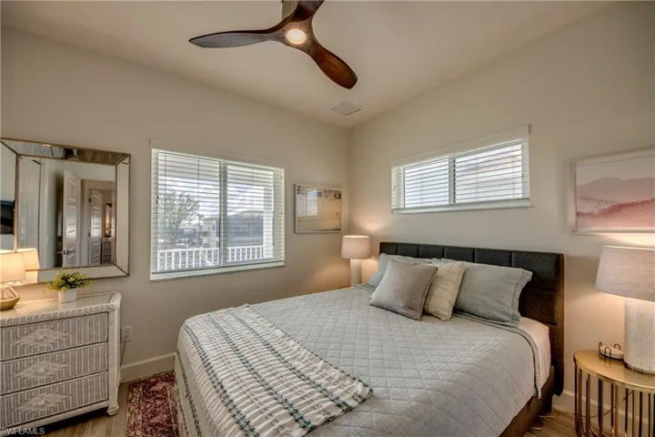Bedroom featuring lofted ceiling, hardwood / wood-style flooring, and ceiling fan