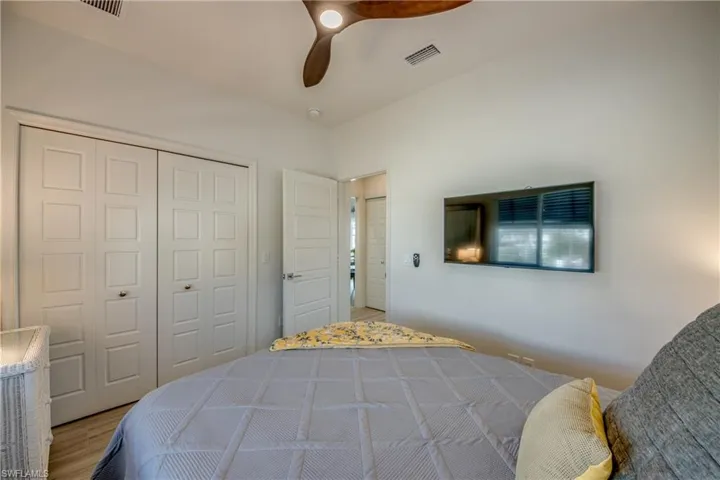 Bedroom featuring hardwood / wood-style floors, a closet, and ceiling fan