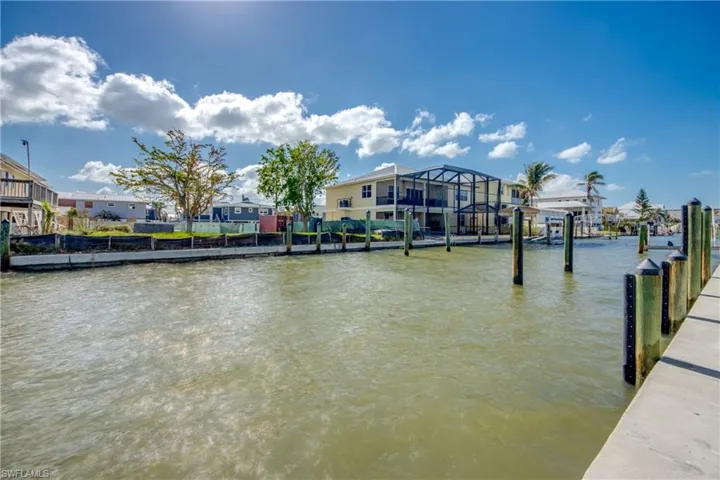 Dock area with a water view and glass enclosure