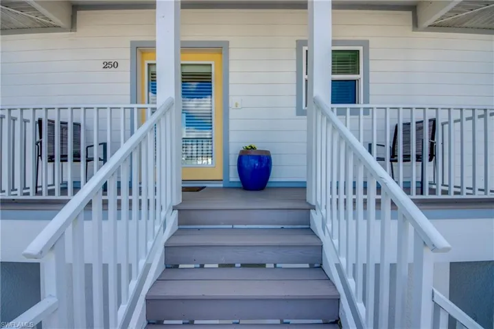 Doorway to property with covered porch