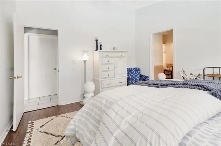 Bedroom featuring dark wood-type flooring and a closet