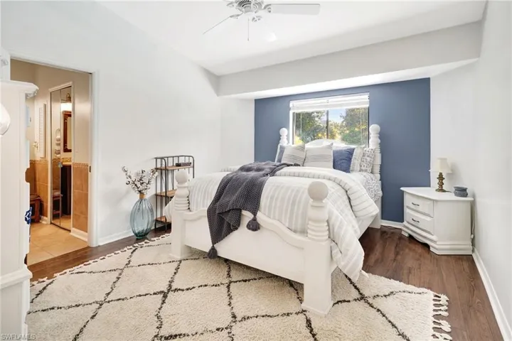 Bedroom with hardwood / wood-style floors and ceiling fan