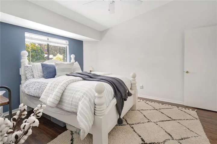 Bedroom featuring ceiling fan and wood-type flooring