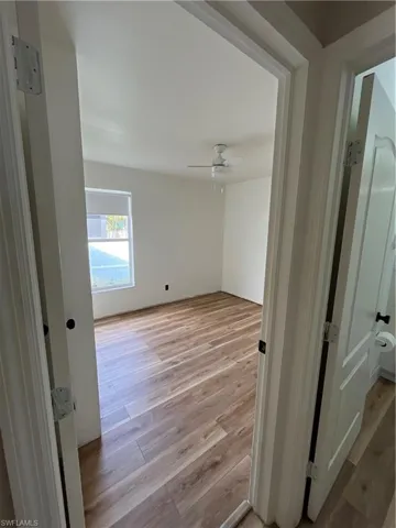 Hallway featuring light wood-style flooring