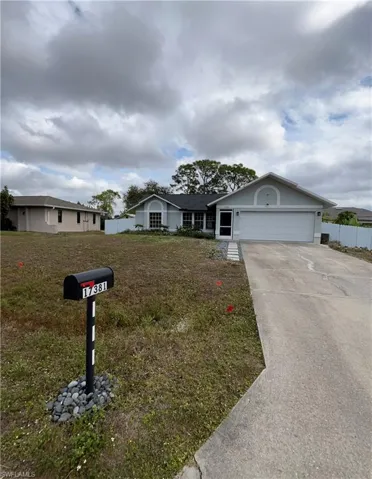 Ranch-style home with concrete driveway and a garage