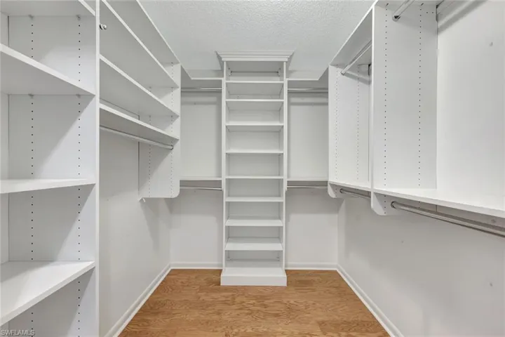 Spacious closet with wood finished floors