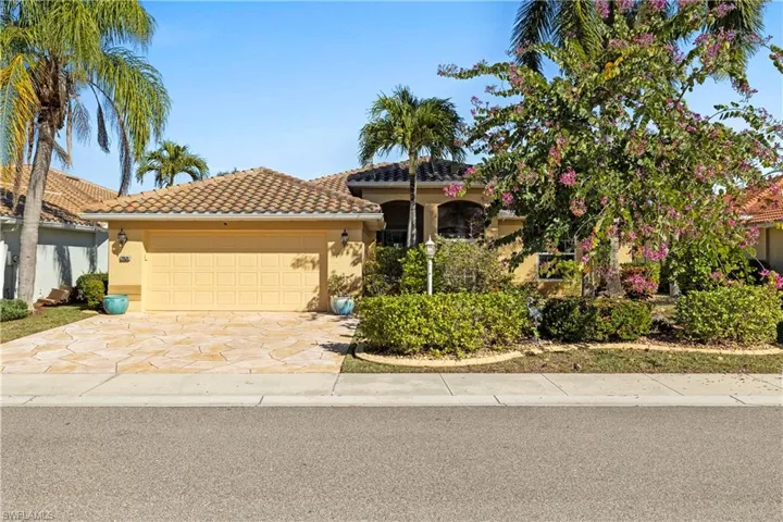 Mediterranean / spanish-style house featuring a tiled roof, stucco siding, driveway, and a garage