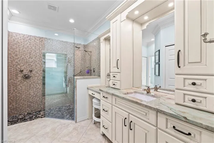 Full bathroom with ornamental molding, a walk in shower, vanity, recessed lighting, and light tile patterned flooring