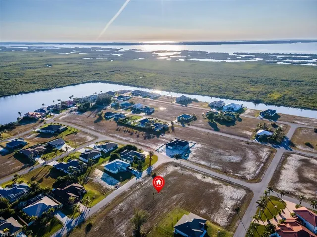 Birds eye view of property with a water view