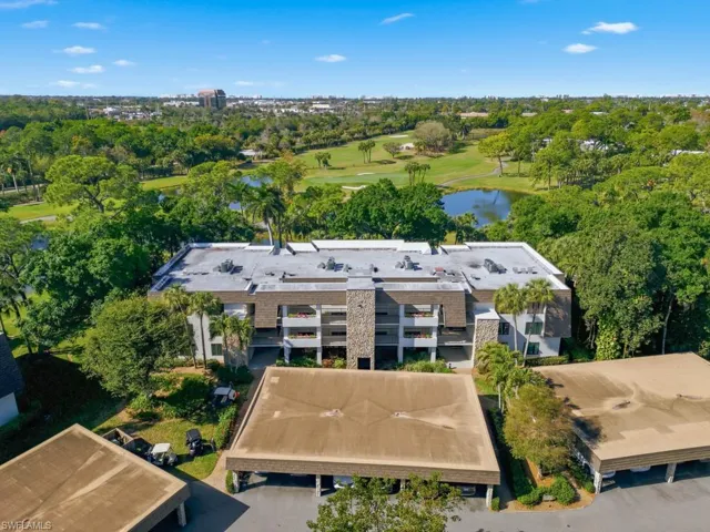 Aerial view of a golf course and a nearby body of water