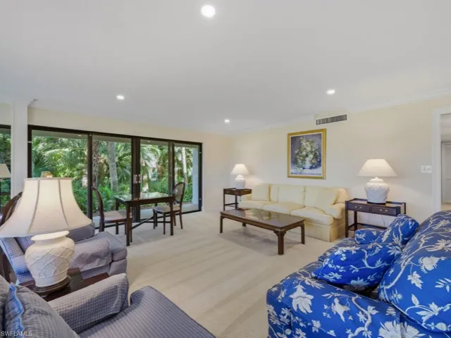 Living room featuring carpet, recessed lighting, and crown molding