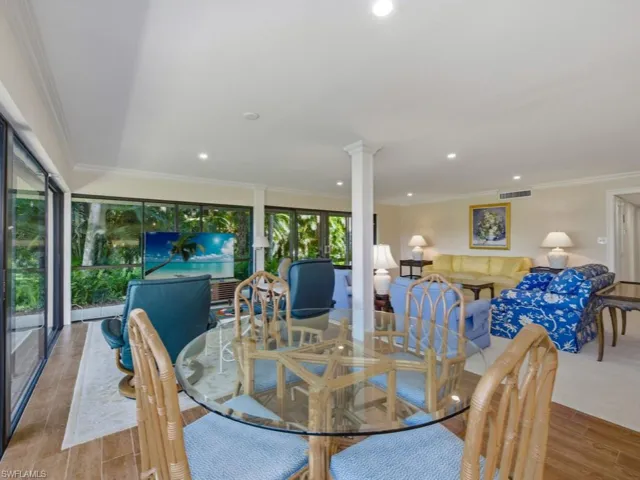Dining space featuring crown molding, wood finish floors, and recessed lighting