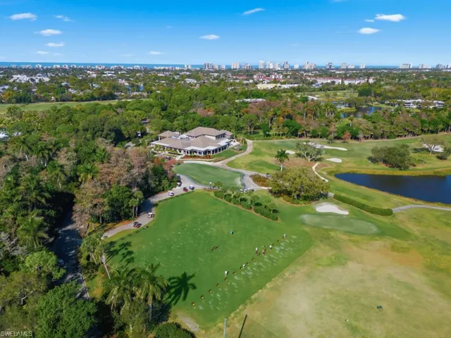 View of urban area featuring a nearby body of water and a tree filled landscape