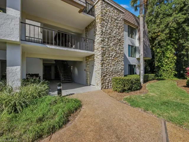 View of property with stairs