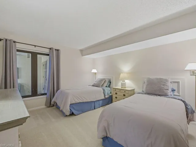 Bedroom with light carpet and baseboards