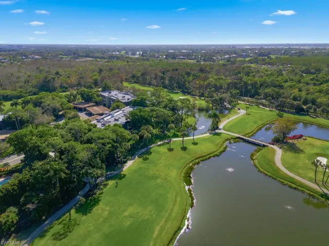 Drone / aerial view of a large body of water and a local golf course