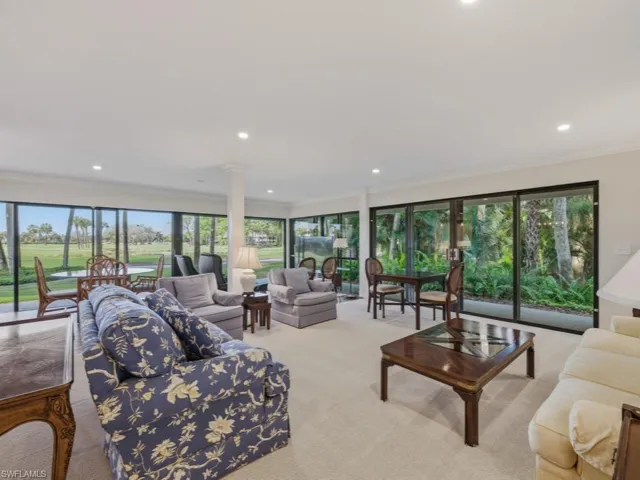 Living room featuring plenty of natural light, ornamental molding, light carpet, and recessed lighting