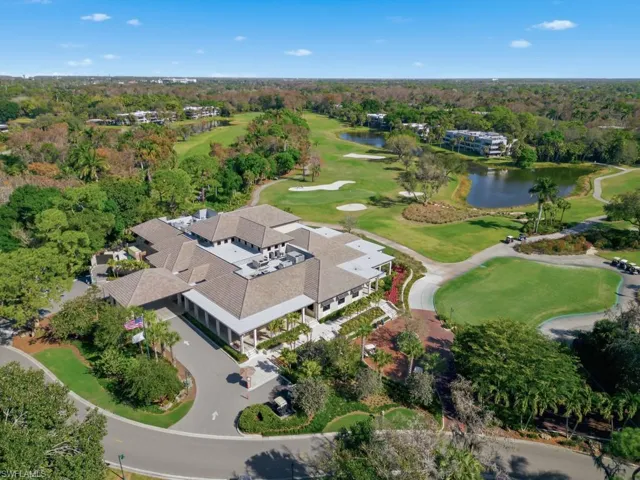 Aerial view of a golf course and a nearby body of water