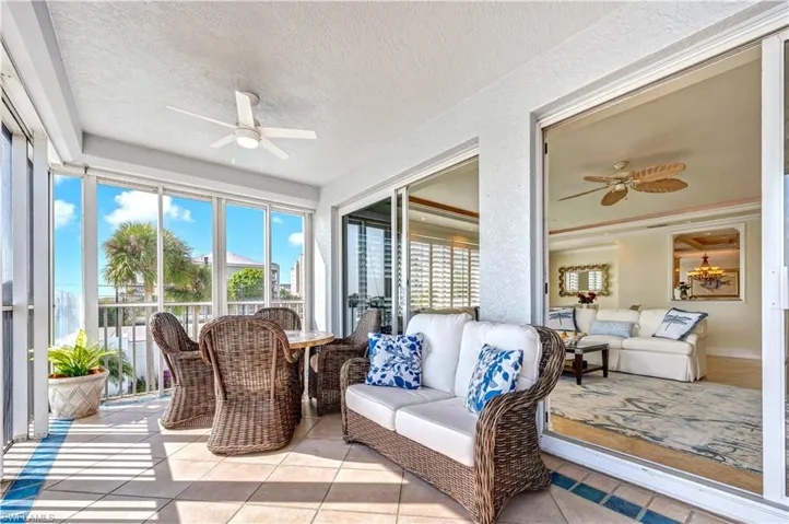 Sunroom featuring ceiling fan
