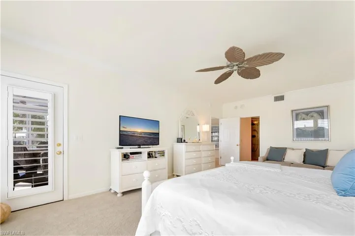 Bedroom with ornamental molding, light colored carpet, access to exterior, and ceiling fan
