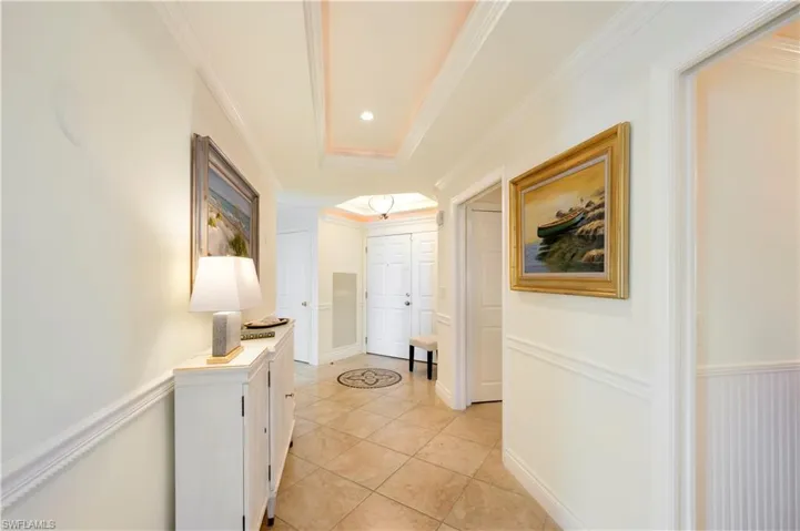 Hall featuring crown molding and light tile patterned floors