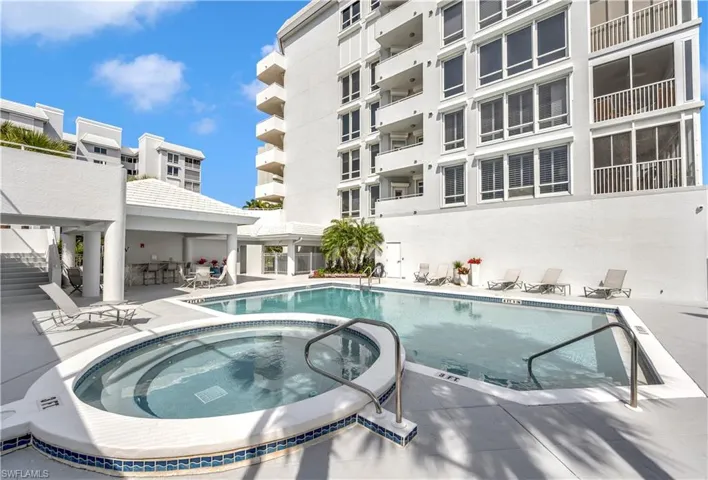 View of swimming pool featuring a community hot tub, a patio, and a gazebo