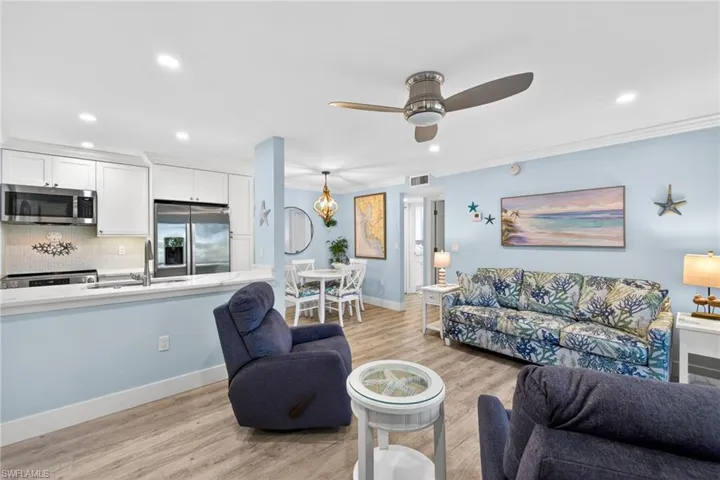 Open-concept living area featuring wood-finish flooring, recessed lighting, and a ceiling fan