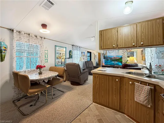 Kitchen with open floor plan and light countertops
