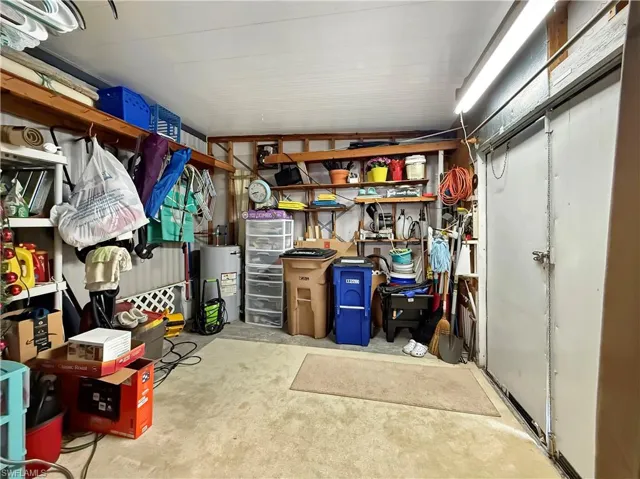 Storage area with water heater and a garage