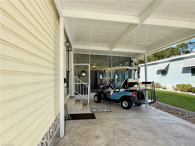 View of screened porch with a carport
