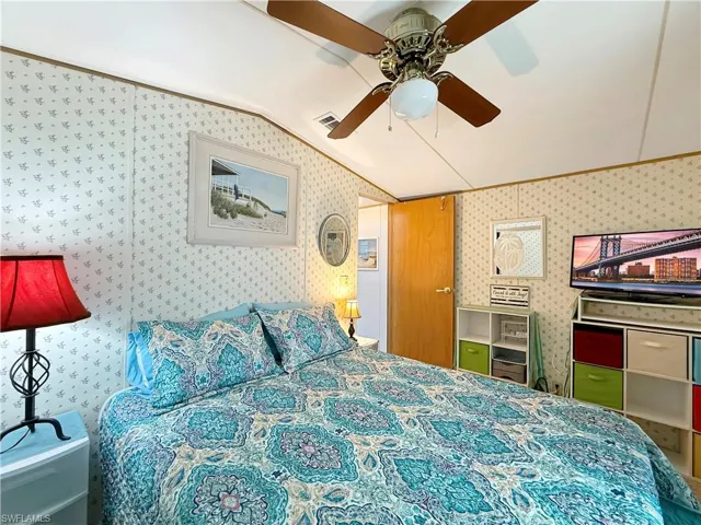 Bedroom featuring vaulted ceiling and a ceiling fan