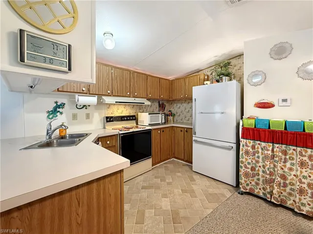 Kitchen with white appliances and light countertops