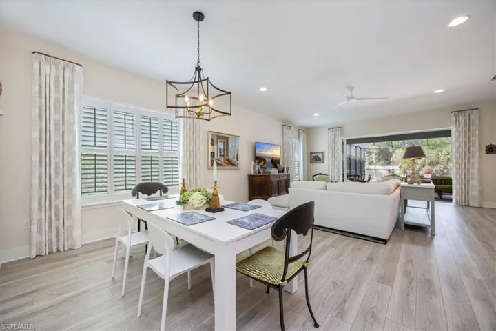 Dining area featuring custom lighting, light wood-style flooring