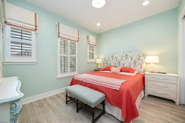 Guest bedroom featuring recessed lighting, plantation shutters and custom window treatments
