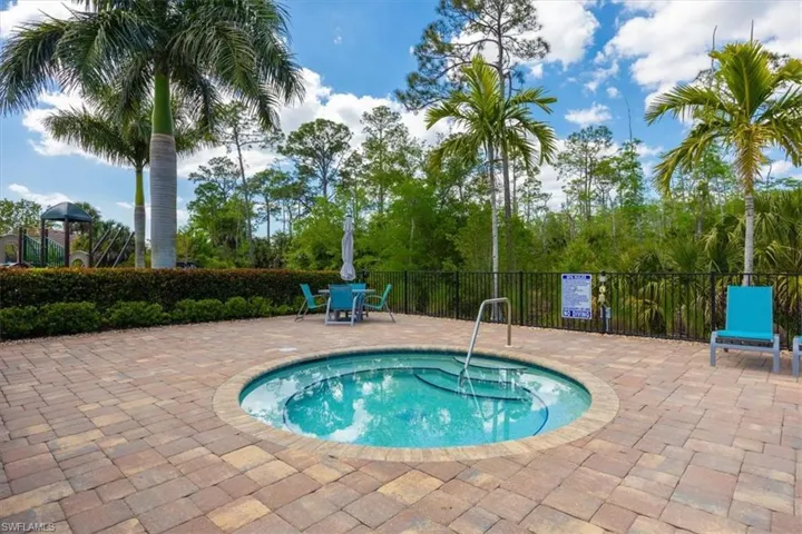 View of swimming pool with a patio area and fence