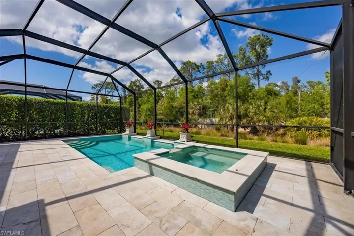 The saltwater, heated pool has glass mosaic tile around it, a Pentair pool system and travertine decking.  The owner also added an autofill (no annoying hoses to fill this pool).