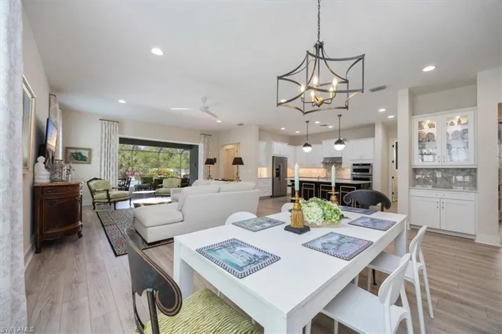 Dining area facing kitchen and showing built in bar