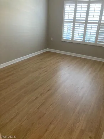 Second bedroom full of light with closet and plantation sshutteers