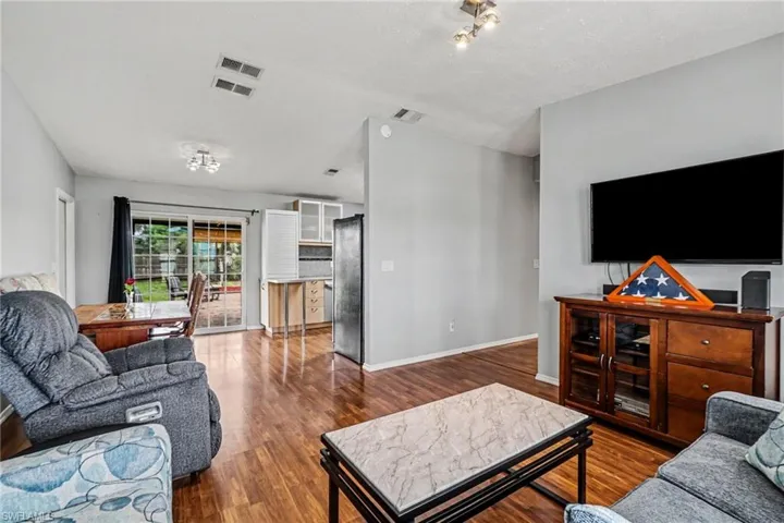 Living area with wood-finish flooring and light gray wall paint