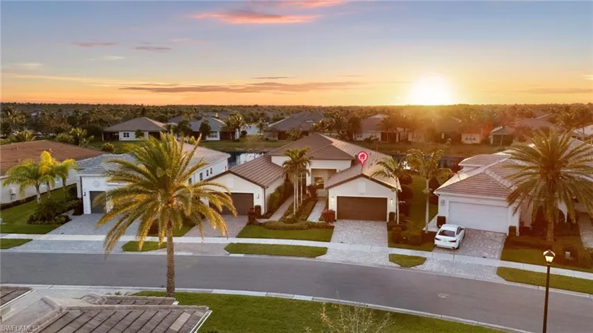 View of front of home featuring decorative driveway and a residential view