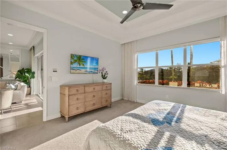 Carpeted bedroom featuring ceiling fan, baseboards, ornamental molding, and recessed lighting
