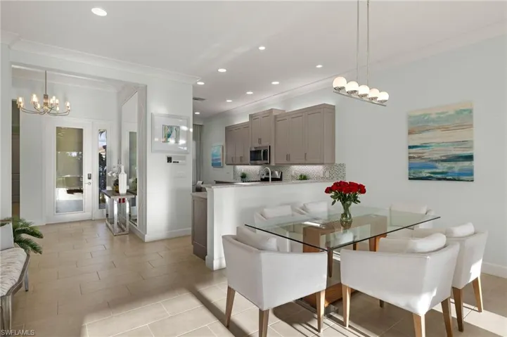 Dining space with an inviting chandelier, baseboards, crown molding, and recessed lighting